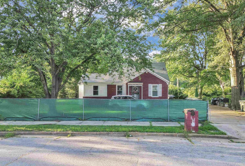 View of front of property with a fenced front yard and brick siding