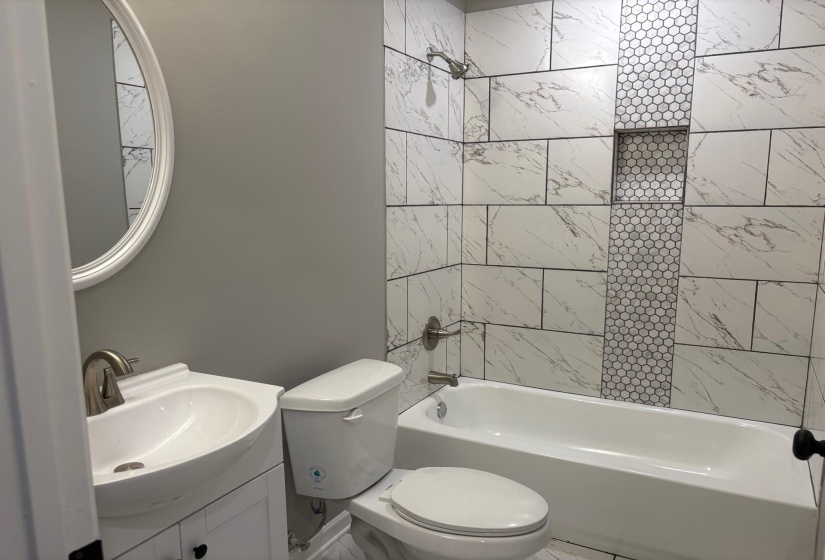 Bathroom featuring washtub / shower combination and vanity