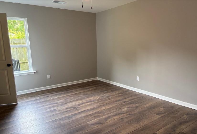 Empty room with dark wood-type flooring
