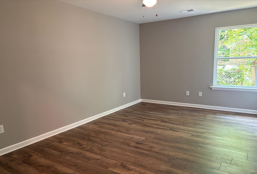 Empty room with dark wood-style flooring