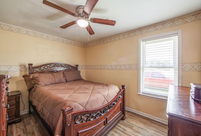 Bedroom featuring wood finished floors and a ceiling fan