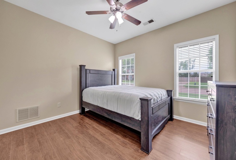 Bedroom featuring wood finished floors, ceiling fan, and vaulted ceiling