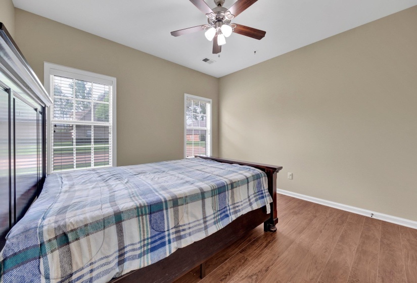 Bedroom with wood finished floors and ceiling fan