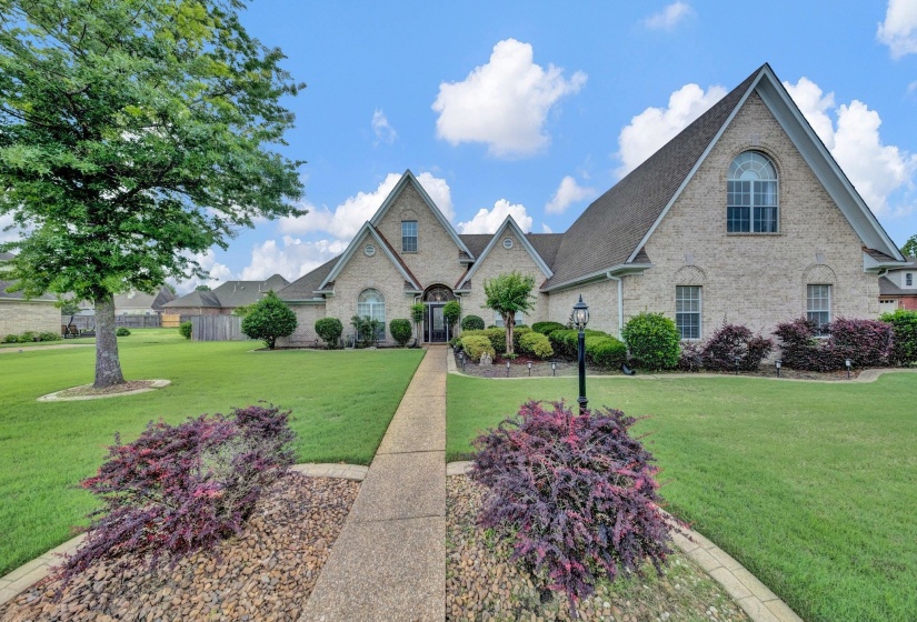 French country home featuring brick siding and a shingled roof