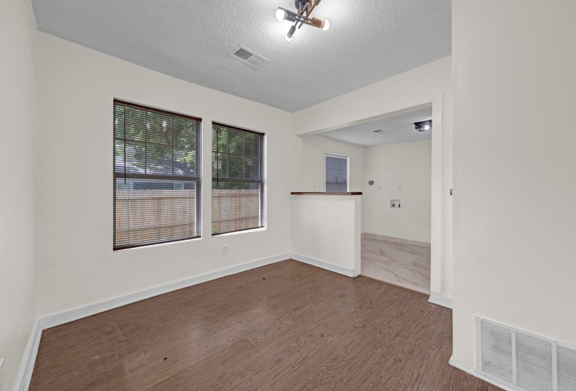 Spare room with a textured ceiling and wood finished floors