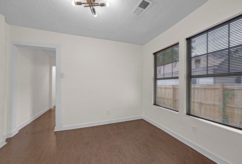 Empty room with dark wood-style floors and a textured ceiling