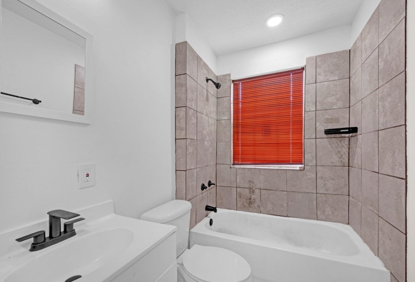 Full bath with bathing tub / shower combination and vanity