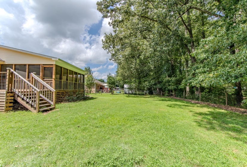 View of yard with a sunroom and stairs