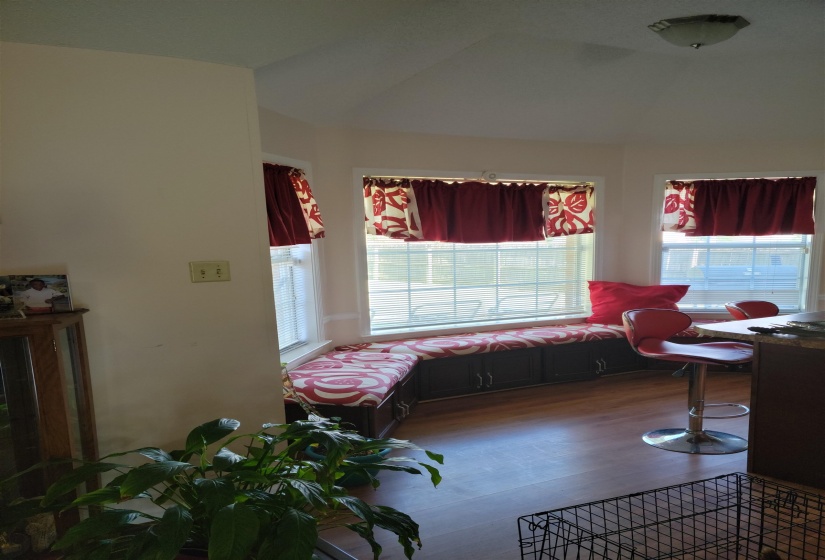 Living area with wood finished floors and vaulted ceiling