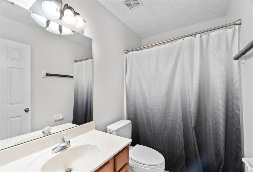 Unfurnished bedroom with wood finished floors and a closet