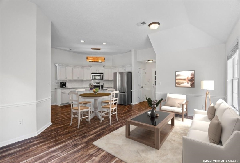 Unfurnished room featuring arched walkways, a ceiling fan, stairs, vaulted ceiling, and light tile patterned floors