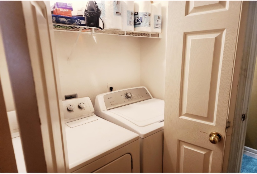 Clothes washing area featuring separate washer and dryer