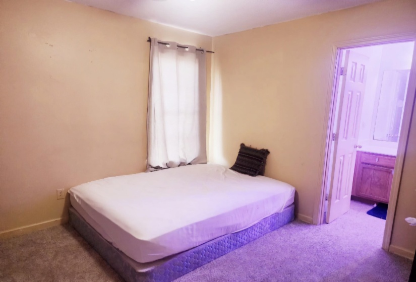 Bedroom featuring light carpet