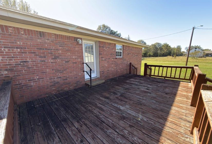 Wooden deck featuring a lawn