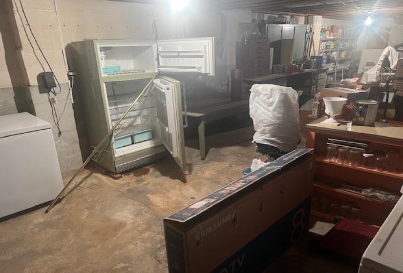 Basement featuring refrigerator