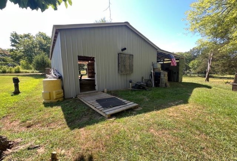 View of outdoor structure with a yard