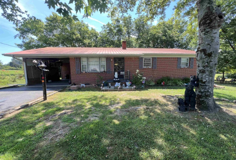 Ranch-style house with a carport and a front lawn