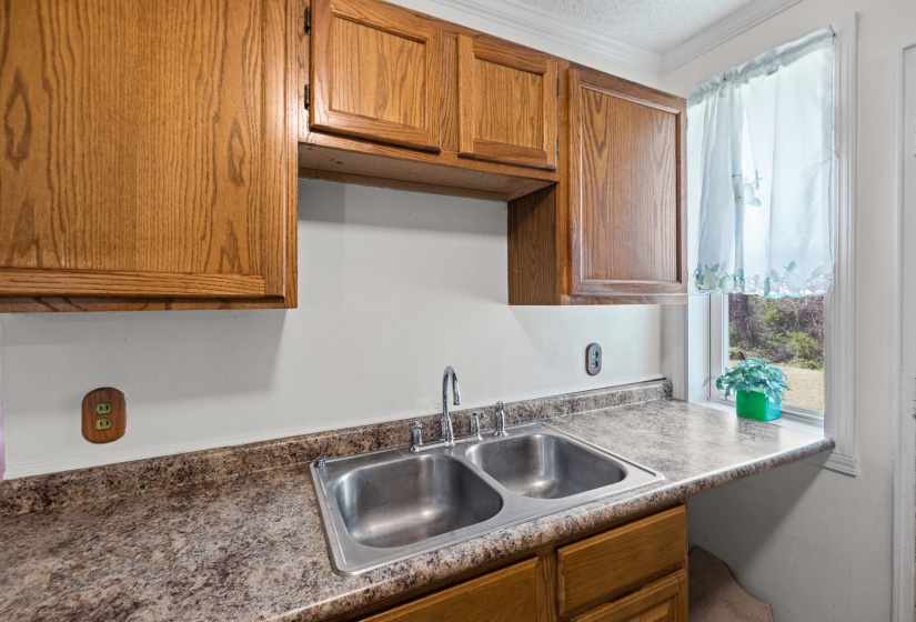 Kitchen with wood finish cabinets and crown molding