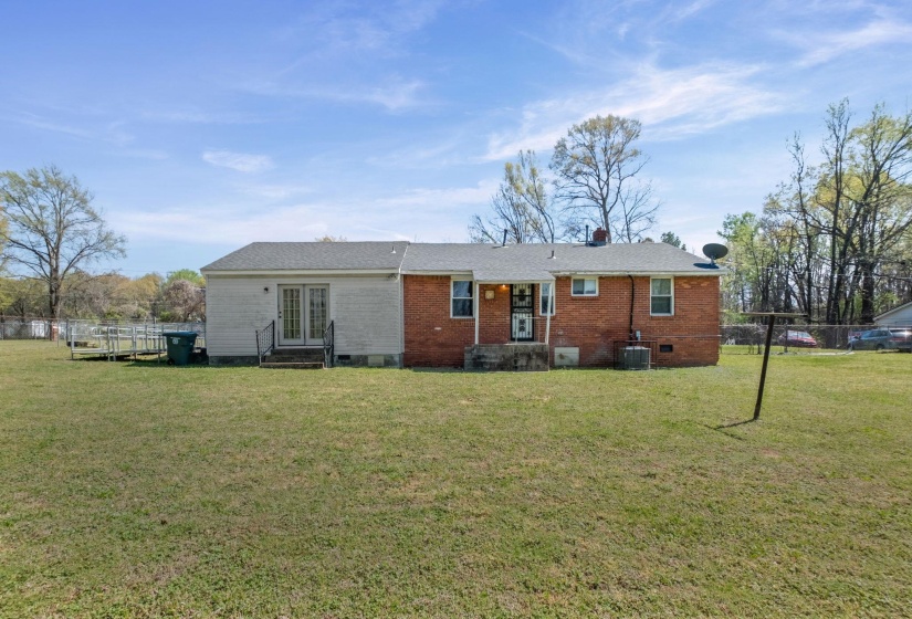 Back of property featuring crawl space, entry steps, brick siding, and french doors