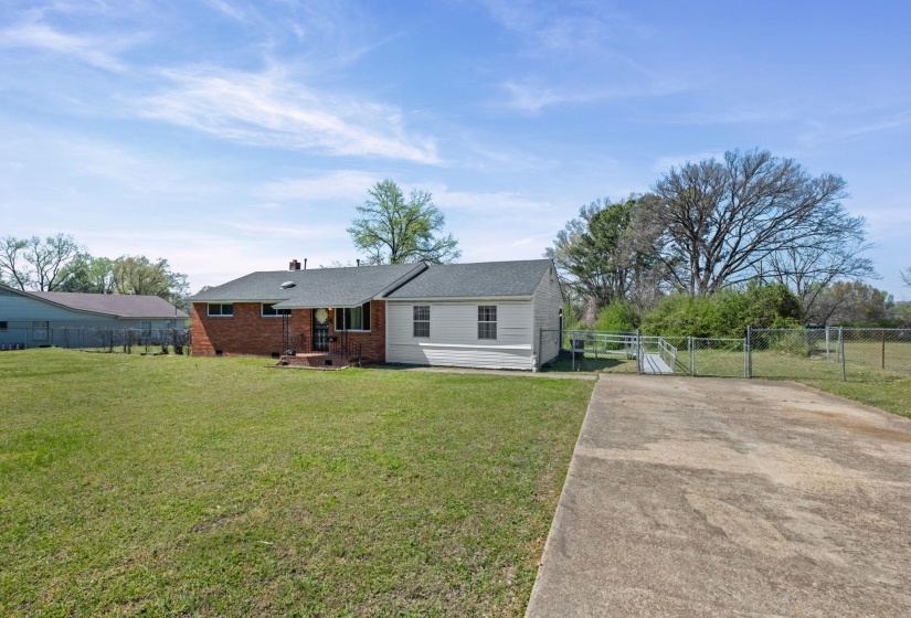 View of front of house featuring a gate, crawl space, driveway, and brick siding