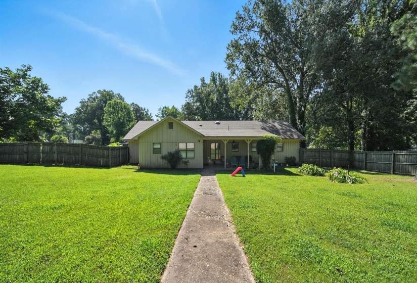 Rear view of house with a fenced backyard