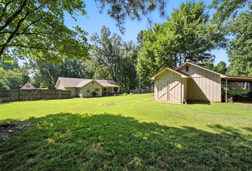 View of yard featuring a shed and view of scattered trees