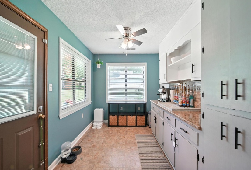 Kitchen with open shelves, a ceiling fan, white cabinets, a textured ceiling, and tasteful backsplash