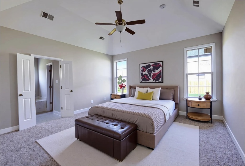 Bedroom with light carpet, multiple windows, lofted ceiling, and a ceiling fan
