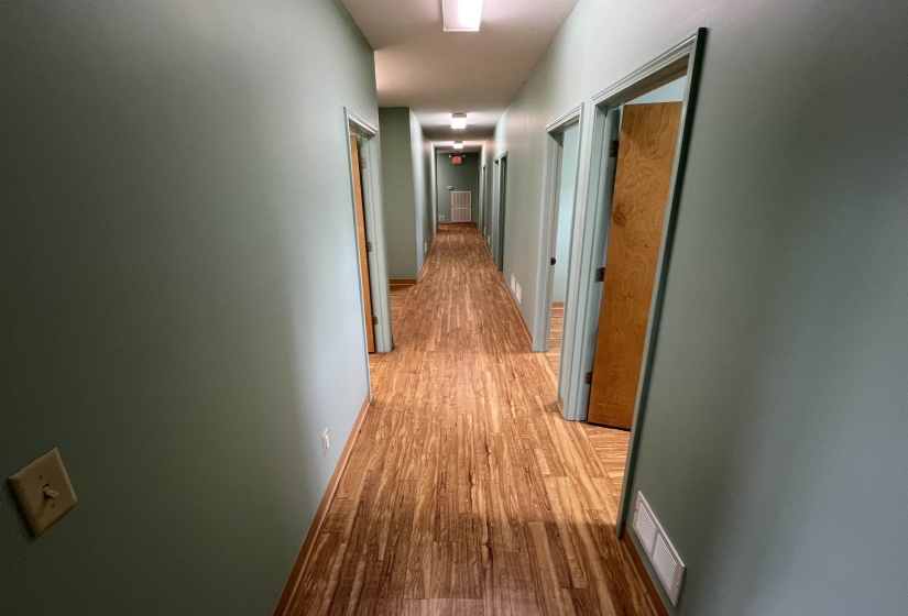 Hallway featuring visible vents and light wood-type flooring
