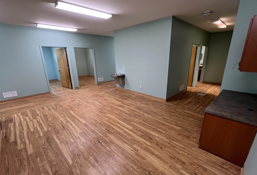 Unfurnished room with visible vents and wood finished floors