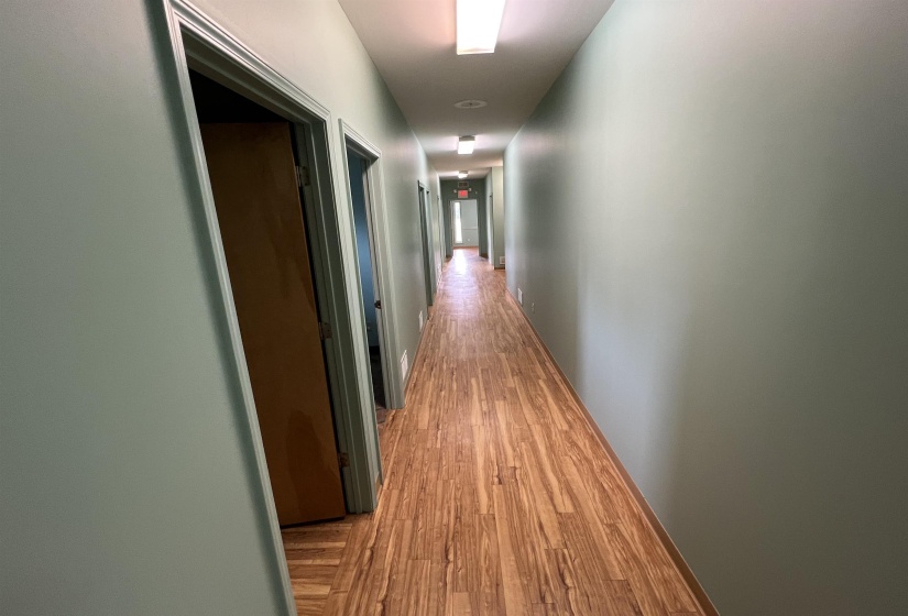 Hallway with light wood-style floors
