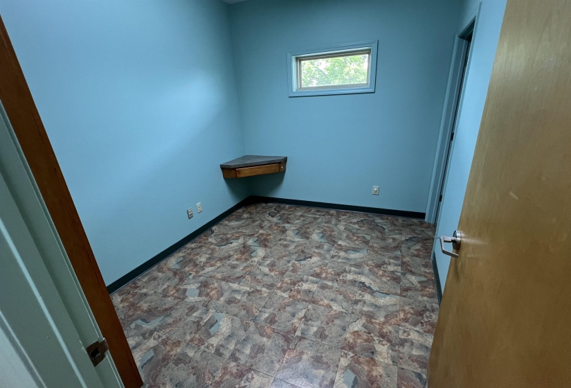 Spare room featuring stone finish flooring and baseboards