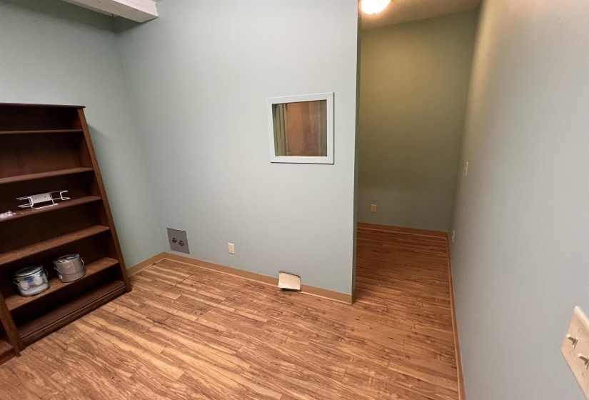 Interior space featuring baseboards and light wood-type flooring