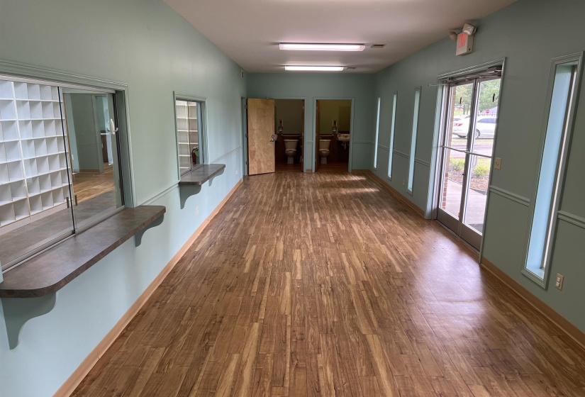 Hallway with baseboards and dark wood finished floors