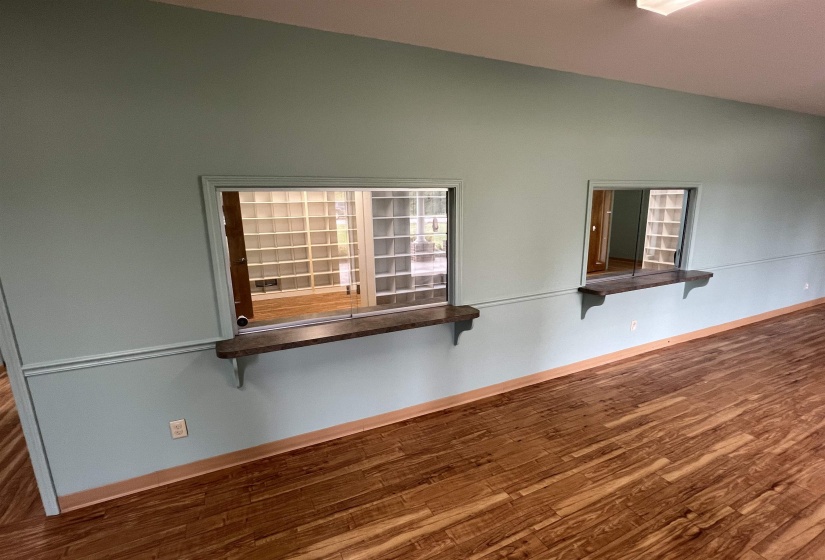 Spare room featuring baseboards and wood finished floors
