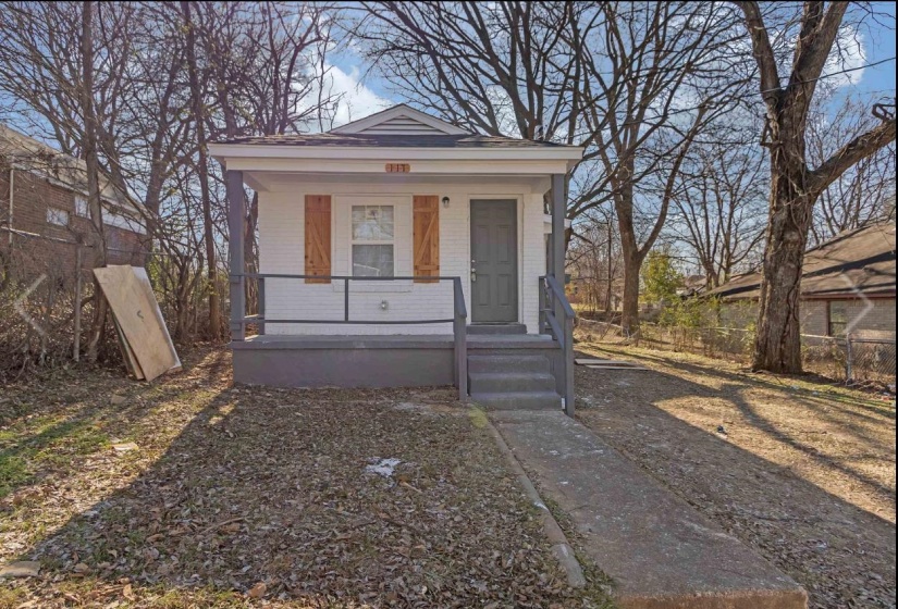 View of front of property featuring covered porch and brick siding