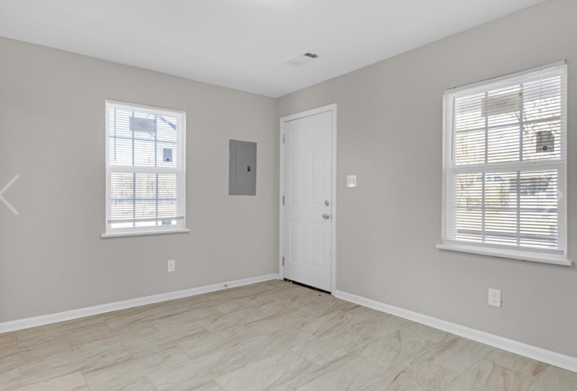 Foyer featuring baseboards and electric panel