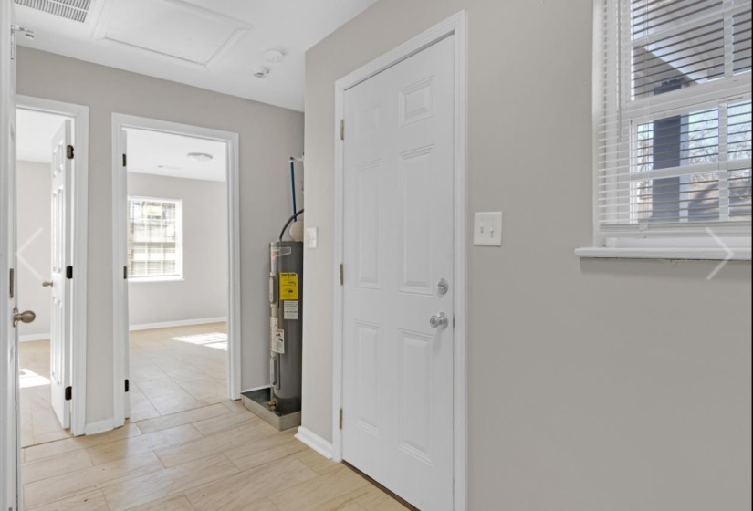 Entryway featuring water heater and light wood-type flooring