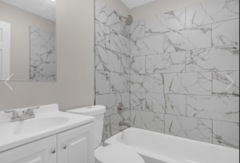 Bathroom featuring vanity and bathing tub / shower combination