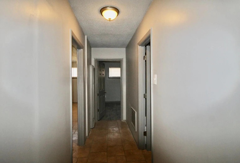 Hallway featuring a textured ceiling