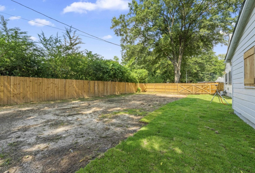 Outside, the newly fenced backyard offers privacy and outdoor enjoyment.