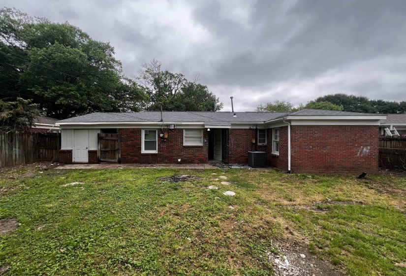 Back of house featuring brick siding and central AC unit
