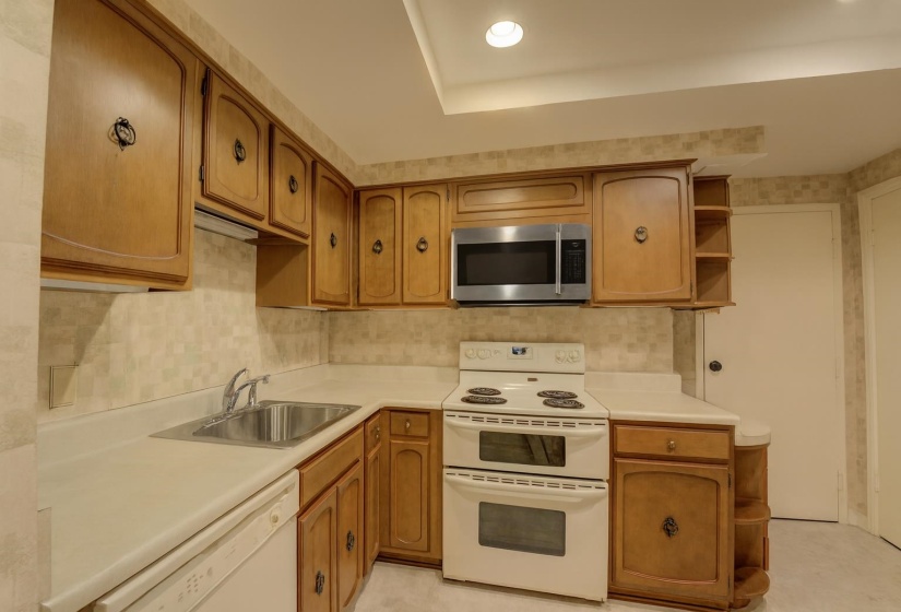 A pantry provides extra storage, recessed lighting illuminates your workspace, and appliances like a double oven, brand new stainless steel microwave, and dishwasher make cooking and cleanup a breeze.