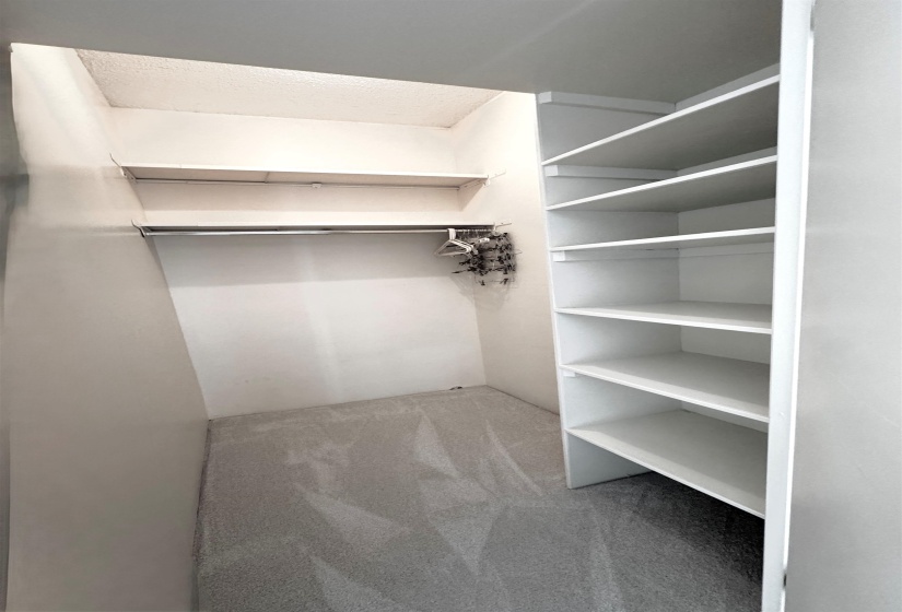 Checkout in awesome walk-in closet in the second bedroom with built-in shelving.