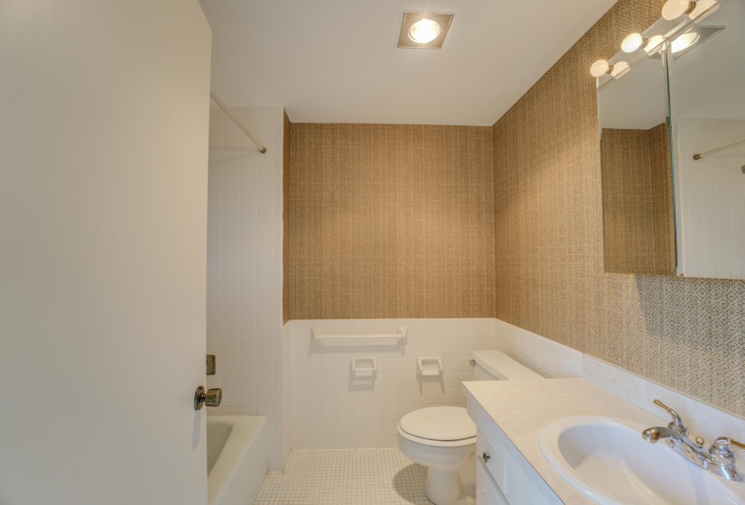 Located off the second bedroom is the bathroom featuring tile patterned floors, vanity, and a shower / bathtub combination.
