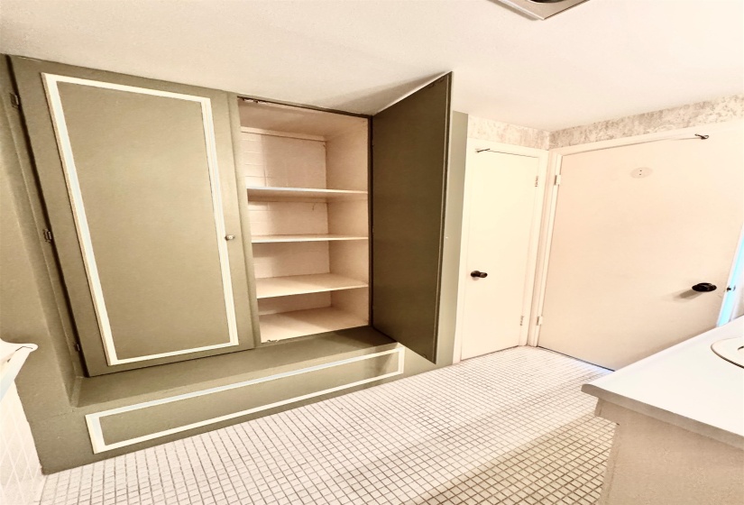 The half bath has a convenient linen closet.