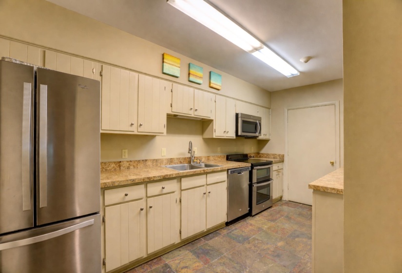 The common area kitchen comes equipped with stainless steel appliances.