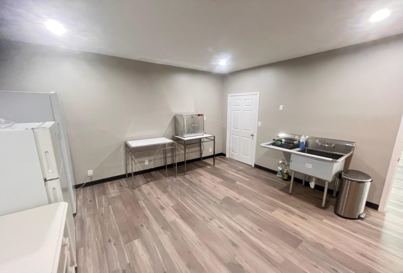Dining area featuring light wood-style flooring and baseboards