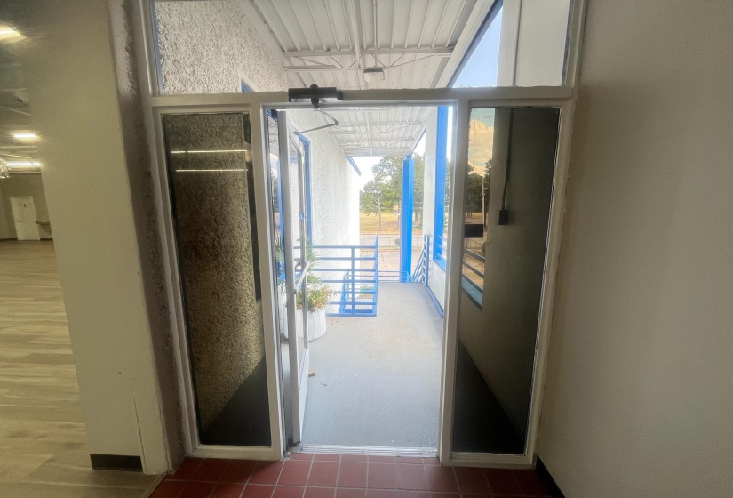 Doorway with tile patterned floors and baseboards