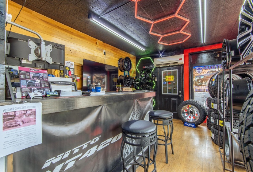 Indoor dry bar featuring wood finished floors, wood walls, and a wall mounted AC